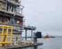 A tugboat tows the LNG production platform from the dry dock at the Novatek‒Murmansk LNG Construction Center