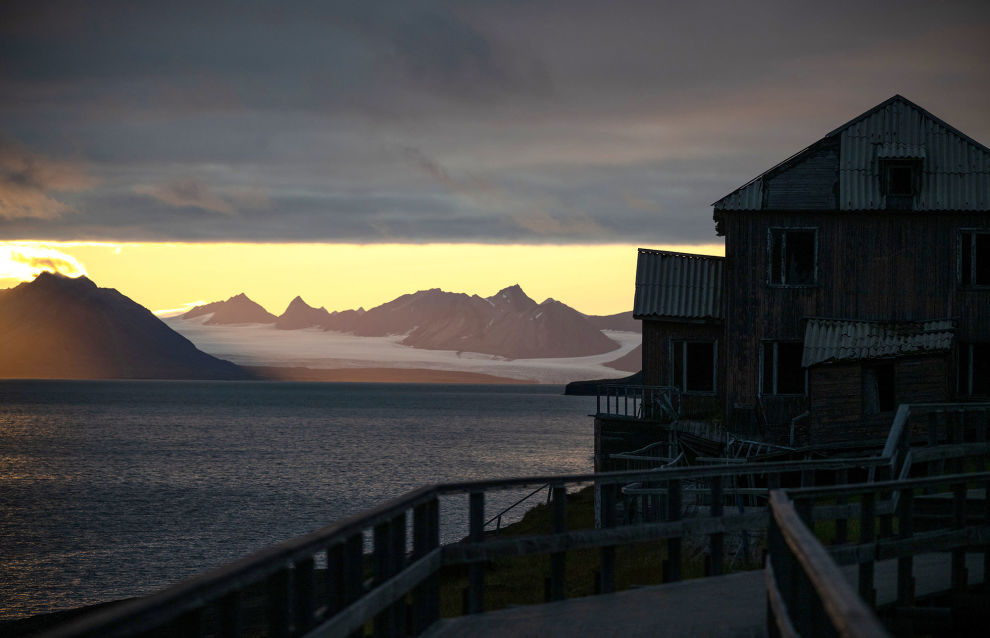 A wooden building is seen on a shore of Arctic Ocean in the settlement of Barentsburg on the Svalbard archipelago
