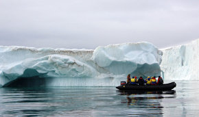 Tourists view the icebergs near Champ Island from inflatable Zodiac boats, Franz Josef Land