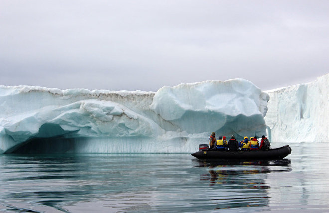 Tourists view the icebergs near Champ Island from inflatable Zodiac boats, Franz Josef Land