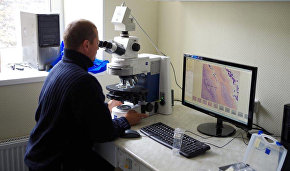 Working with a microscope at the Russian scientific center’s chemical laboratory on Spitsbergen (Svalbard)