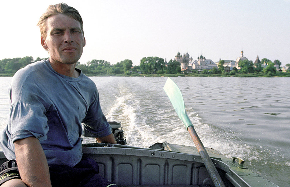 A Pomor sits in a boat on a river near the village of Nenoksa