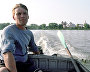 A Pomor sits in a boat on a river near the village of Nenoksa