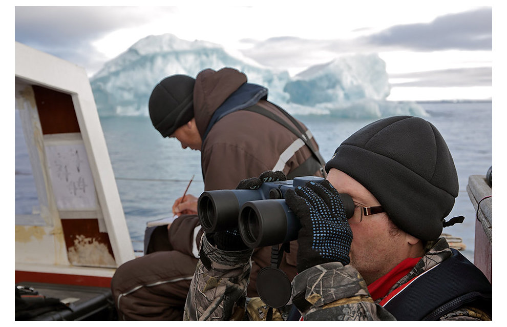 Expedition members Dmitry Moseyev and Yevgeny Kuzmin aboard the yacht monitor the island coastal zone
