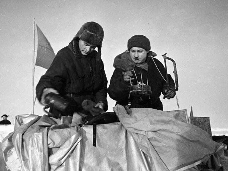 Ivan Papanin (right) and Pyotr Shirshov [left] pack kitchen utensils during evacuation of SP-1 polar station