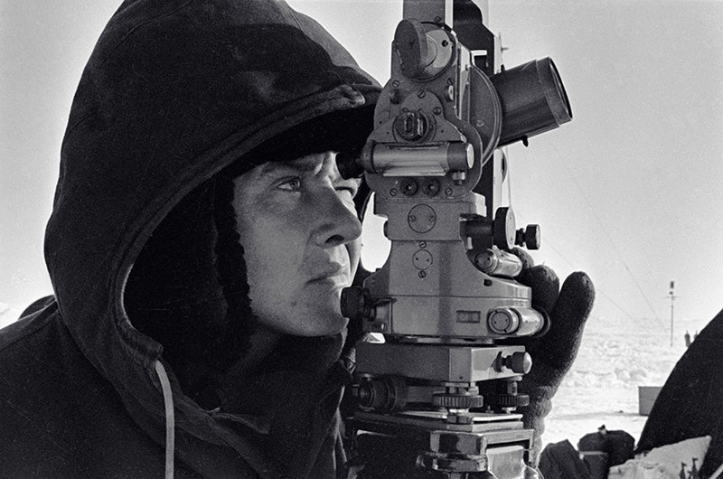 A land surveyor at the SP-11 scientific station studying the area
