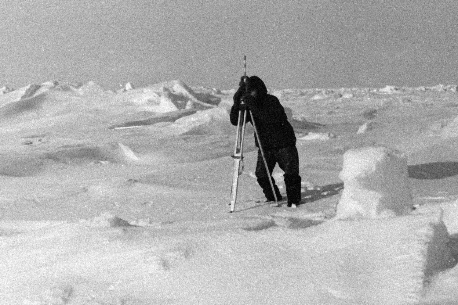 A magnetologist of the North Pole-12 station in the Arctic taking bearings of the station