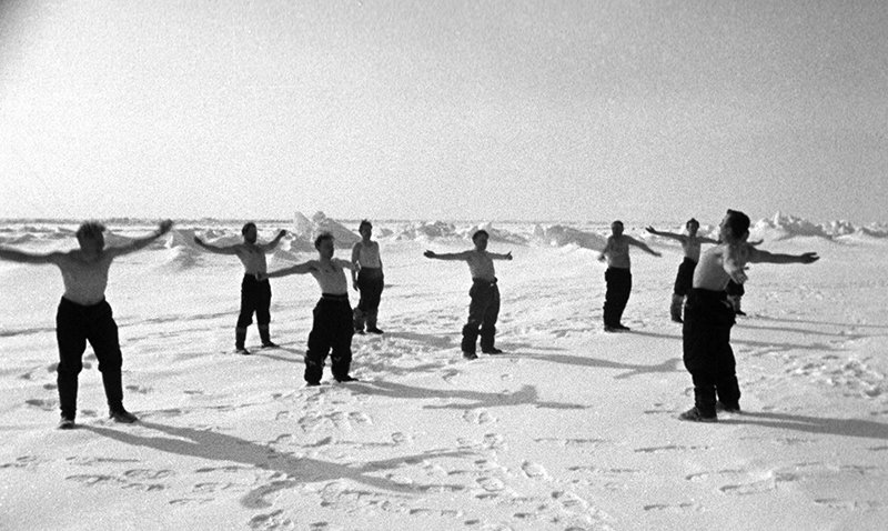 Polar explorers doing morning exercises