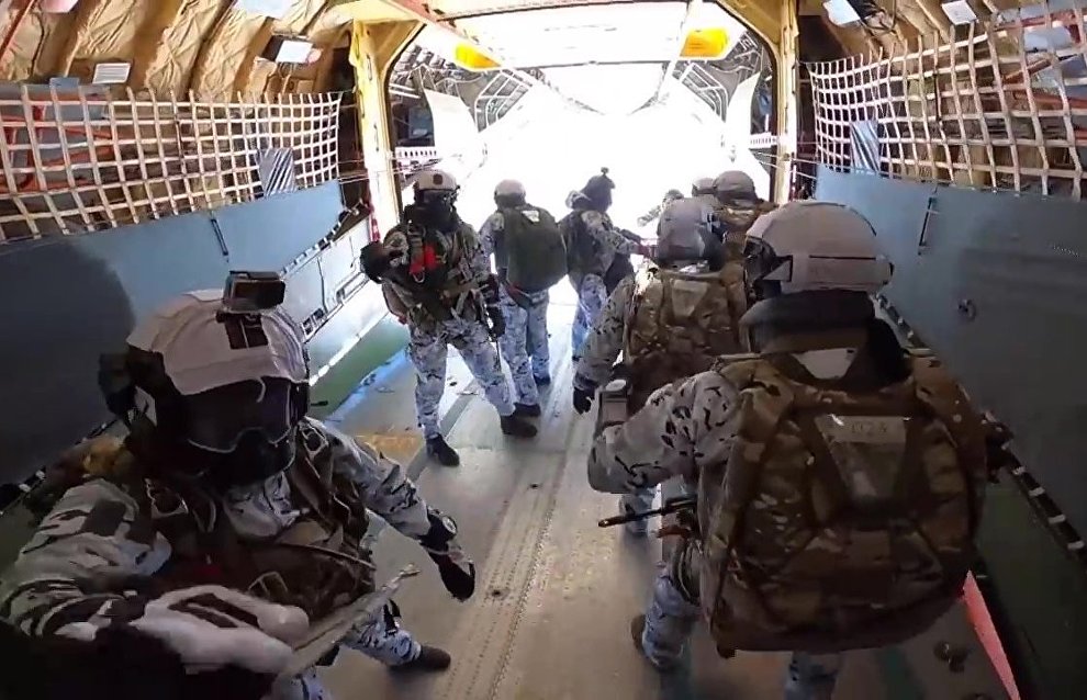 Russian paratroopers perform a group jump from an Ilyushin Il-76 aircraft from 10,000 m of altitude, using parachute systems in the extreme Arctic conditions near the Franz Josef Land Archipelago