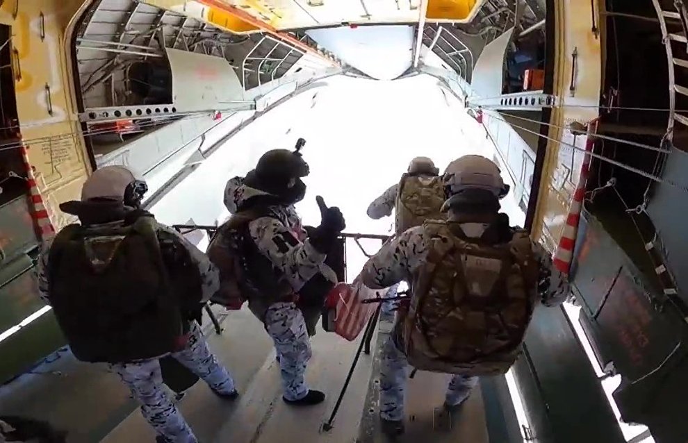 Russian paratroopers perform a group jump from an Ilyushin Il-76 aircraft from 10,000 m of altitude, using parachute systems in the extreme Arctic conditions near the Franz Josef Land Archipelago