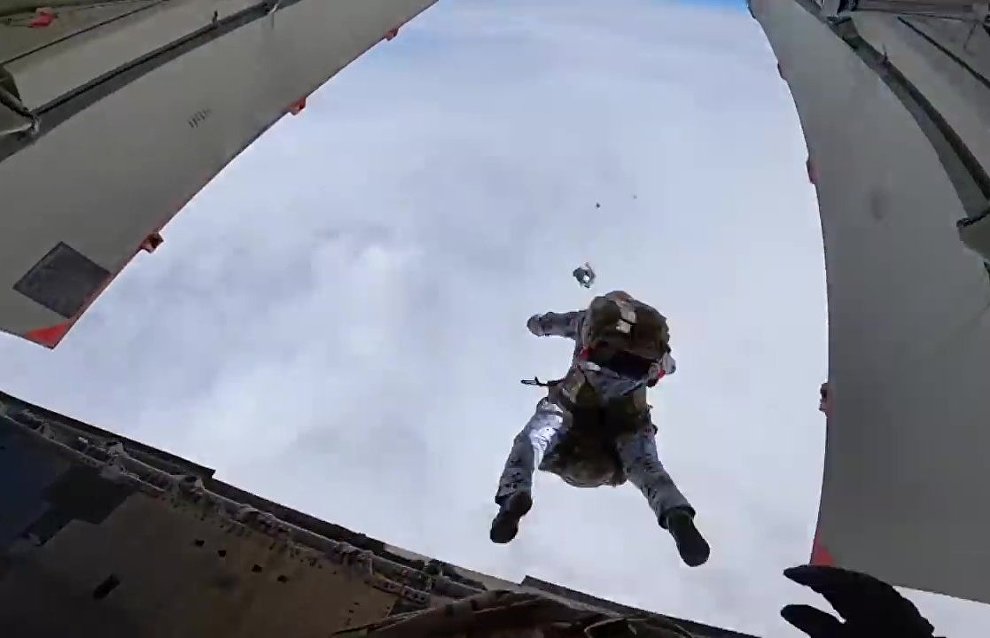 Russian paratroopers perform a group jump from an Ilyushin Il-76 aircraft from 10,000 m of altitude, using parachute systems in the extreme Arctic conditions near the Franz Josef Land Archipelago