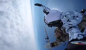 Russian paratroopers perform a group jump from an Ilyushin Il-76 aircraft from 10,000 m of altitude, using parachute systems in the extreme Arctic conditions near the Franz Josef Land Archipelago