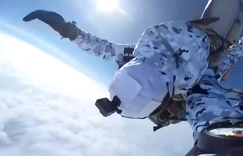 Russian paratroopers perform a group jump from an Ilyushin Il-76 aircraft from 10,000 m of altitude, using parachute systems in the extreme Arctic conditions near the Franz Josef Land Archipelago