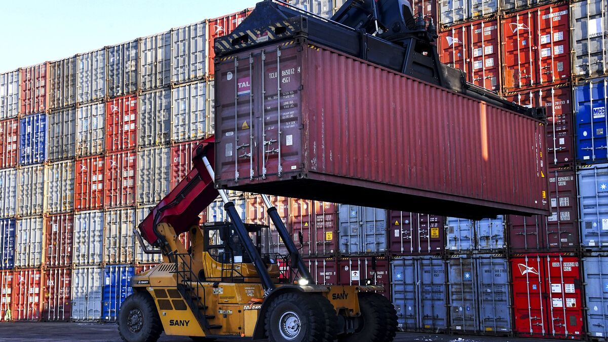Loading containers at a container terminal of a merchant seaport