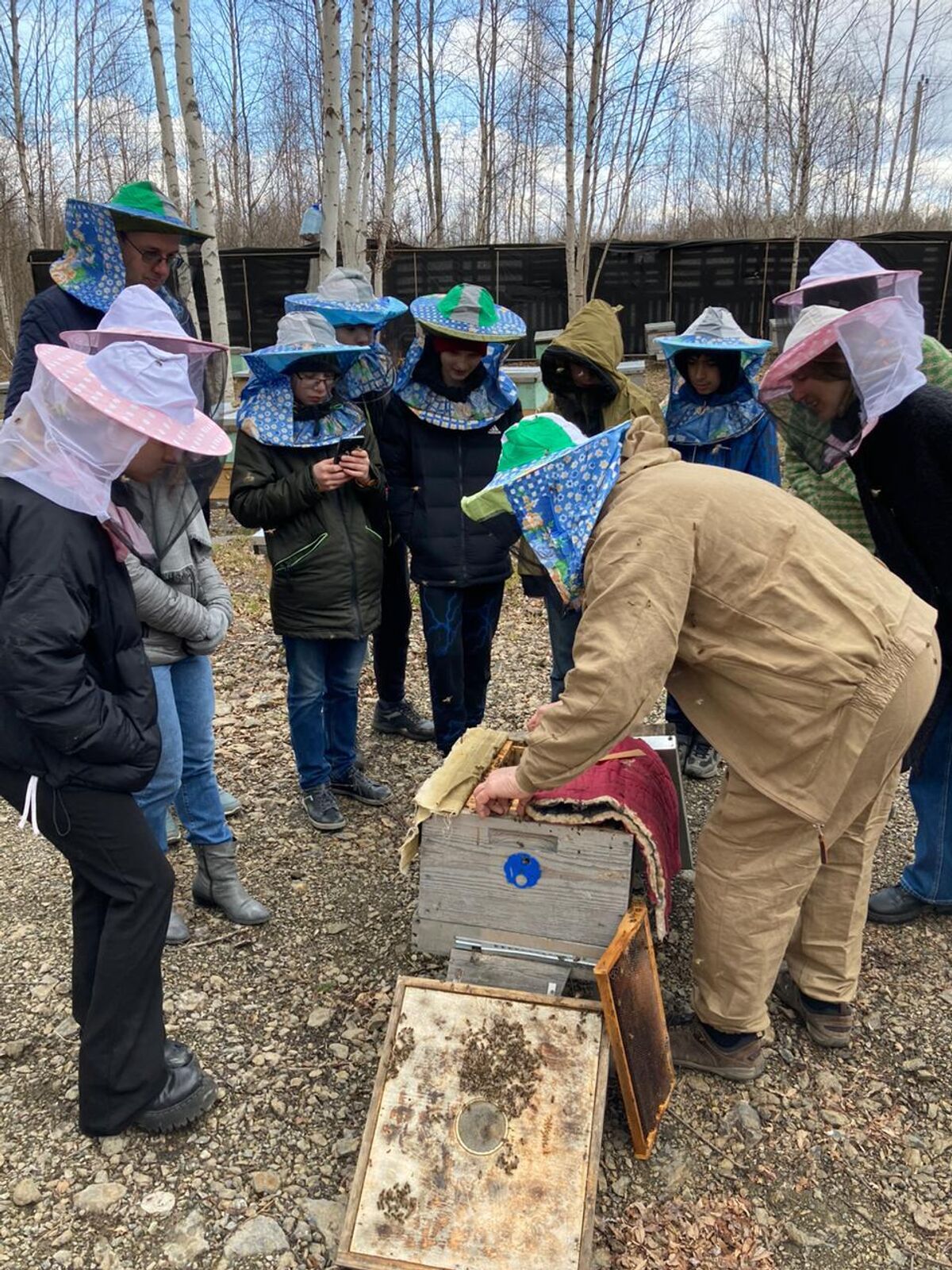 Sergei Surovtsev conducts a guided tour of his apiary 