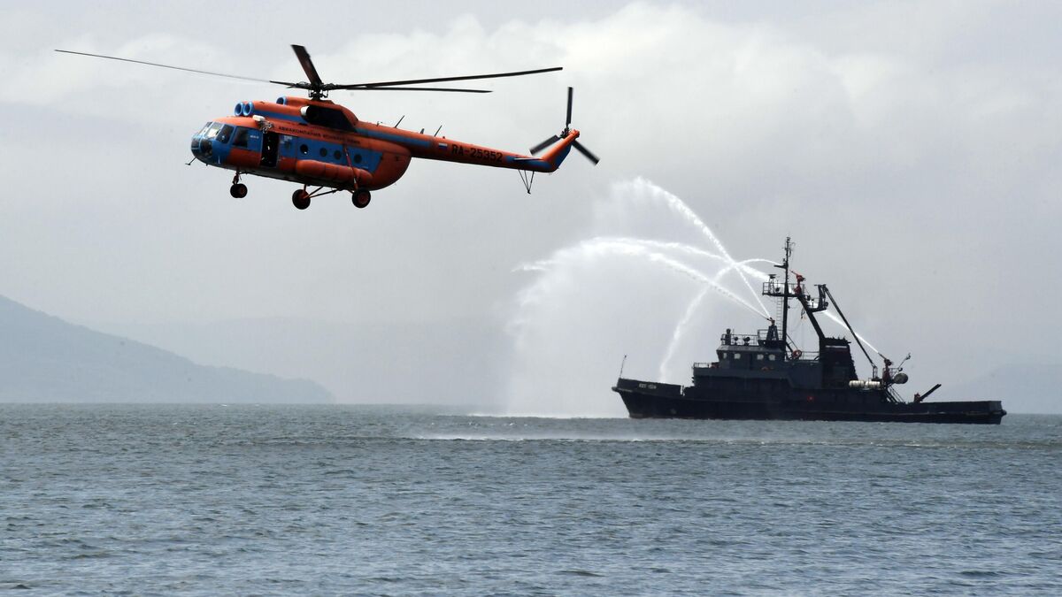 A multi-role salvage-and-rescue vessel and a Mil Mi-8 helicopter 