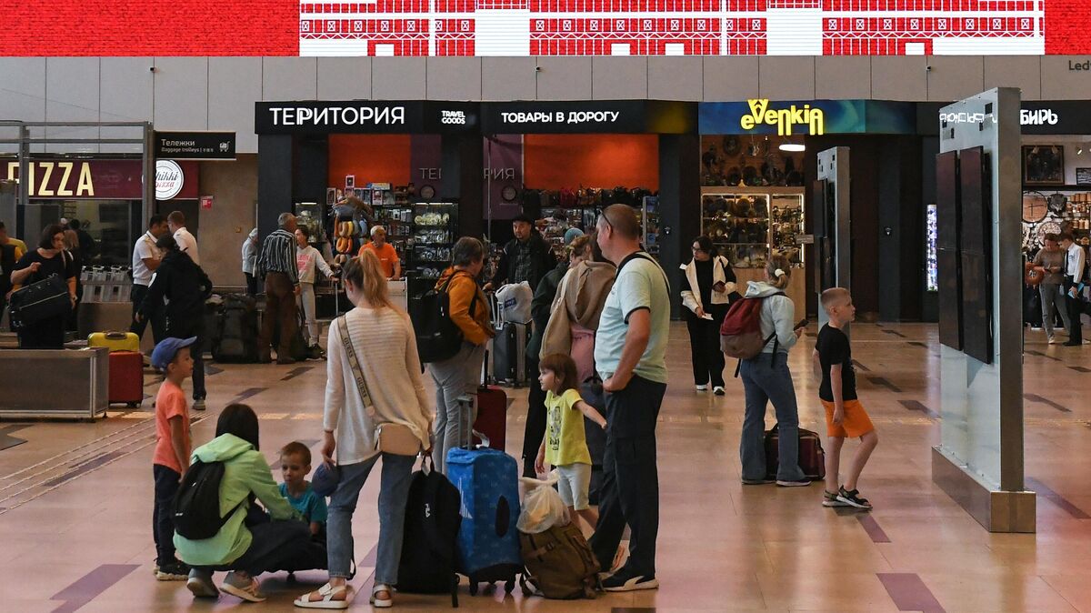 Passengers with children at Dmitry Khvorostovsky International Airport in Krasnoyarsk