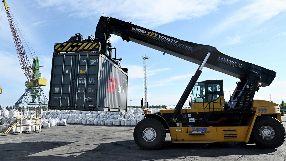 A forklift truck carries a container for subsequent transportation by river under the northern deliveries program A forklift truck carries a container for subsequent transportation by river under the northern deliveries program