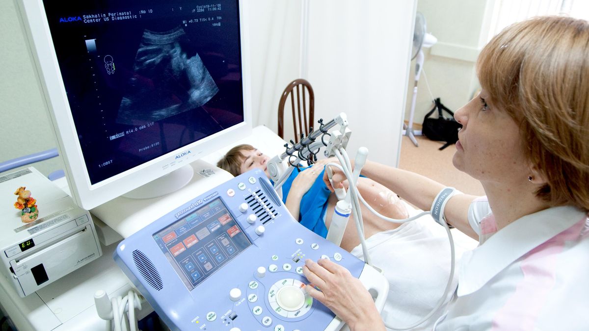 A pregnant woman undergoes an ultrasound examination 