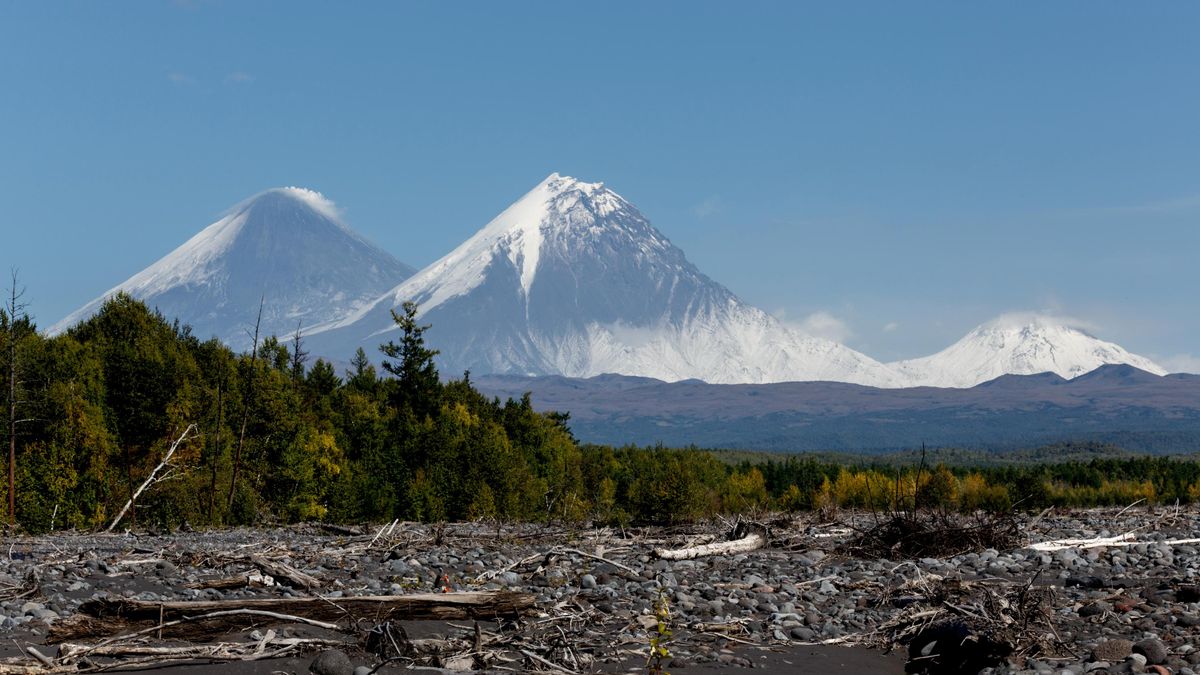 View of Klyuchevskoi, Kamen and Bezymyanny volcanoes from the channel of the Studyonaya River in Kamchatka  