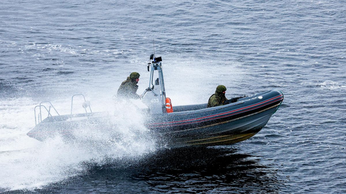 Military personnel on a naval boat during an exercise